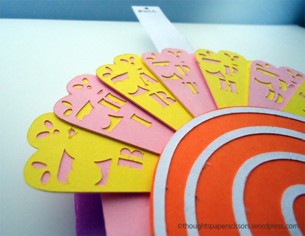 Close up of the fan which was made with two pieces of card; one with a cut out pattern the other plain. Both glued together